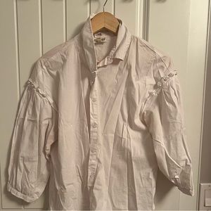 White shirt with pearls on the sleeves